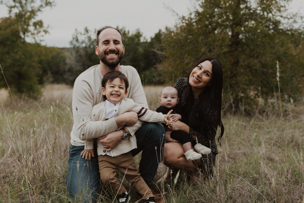 Family smiling together during their Texas hill country family photos.