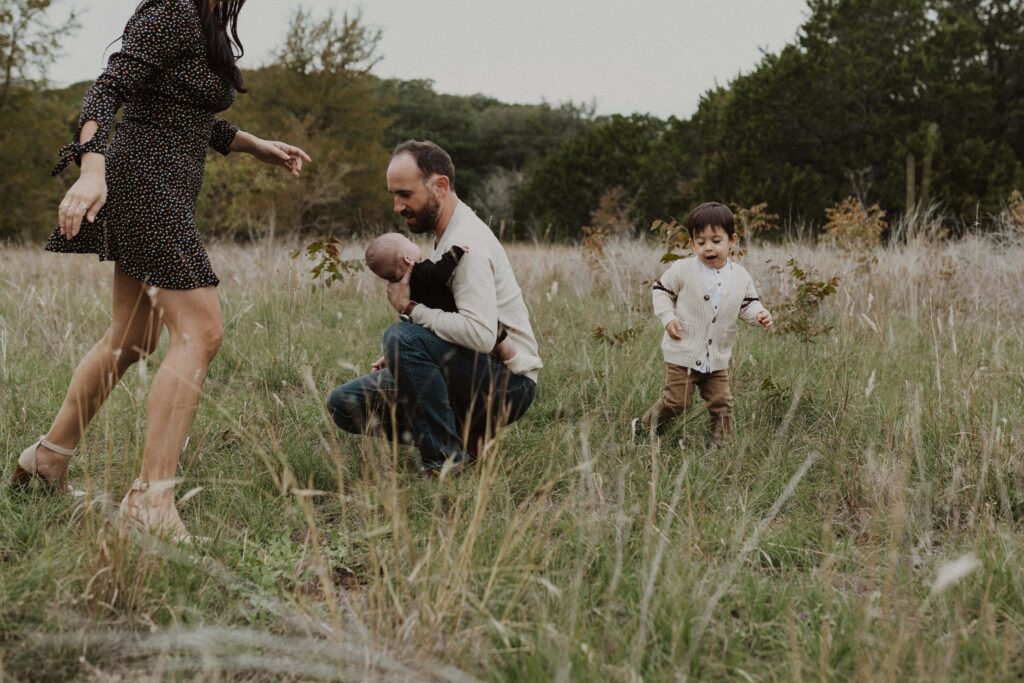 Mom and son playing a game of tag during their Texas hill country family photos.